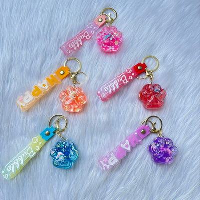 Unicorn inside paw water glitter keychain