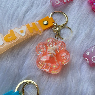 Unicorn inside paw water glitter keychain